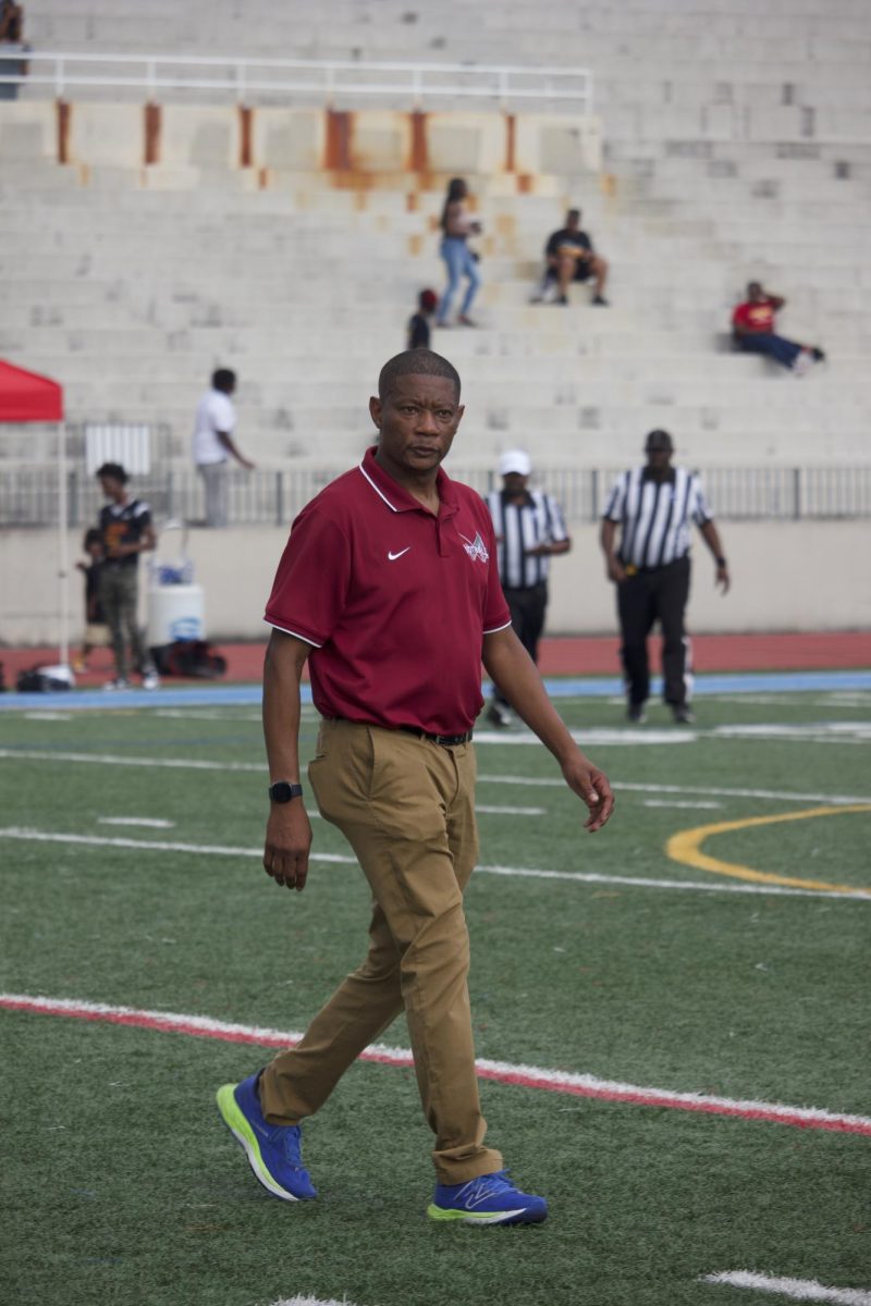 New football head coach Delbert Ellerton walks on to the field in preparation for the Knights scrimmage against Maynard Jackson on Aug. 11. The team is 2-2 in the regular season. 