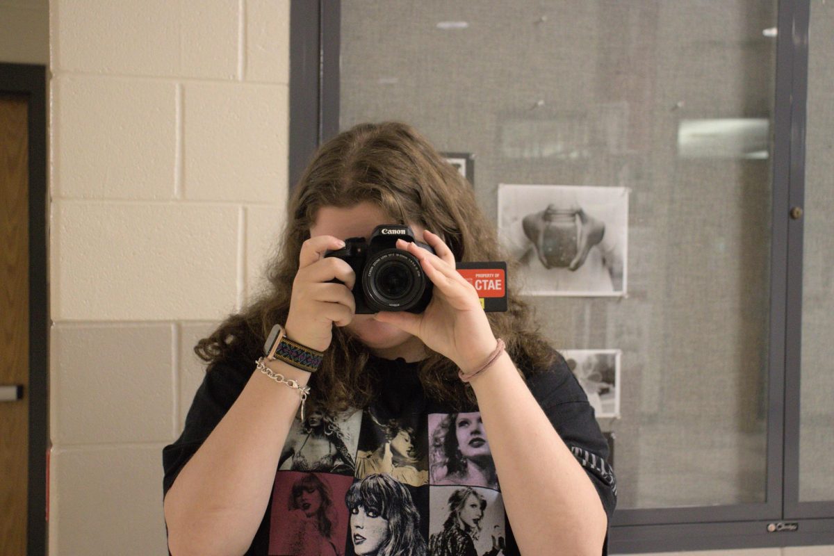 Junior Ruby Segerman practices taking photos on a digital camera in preparation for next year. 