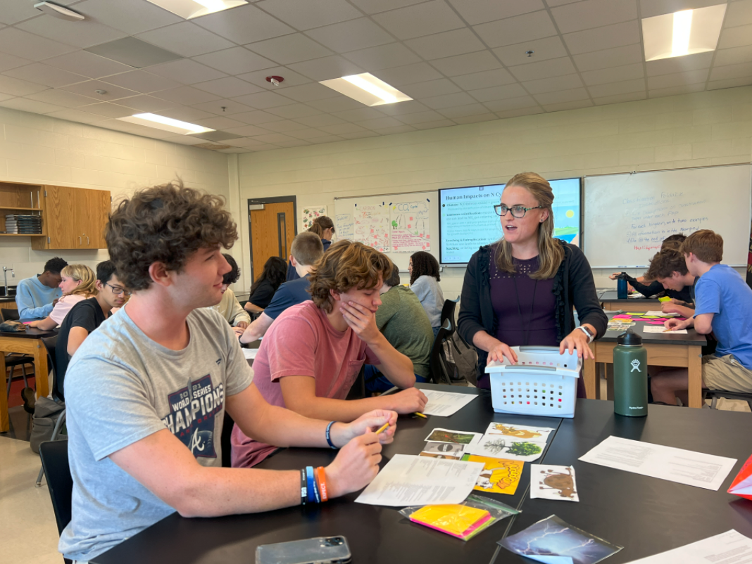 Laura+Rogers+discusses+an+activity+with+Harrison+Briggs+and+Christian+Timmons+in+AP+Environmental+Science.+Rogers+intends+to+focus+more+on+interactive+activities+and+working+with+students%2C+rather+than+lecturing.