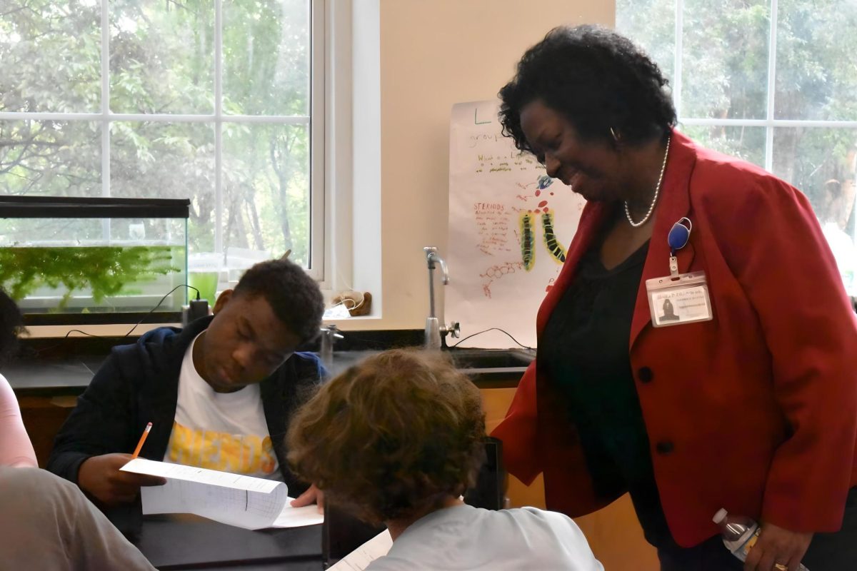 APS interim Superintendent Dr. Danielle Battle looks over students as they complete their science work during her visit to Midtown on Oct. 6. Dr. Battle appointed six new figures to her senior leadership team who, like her, pledge to focus on student achievement. 