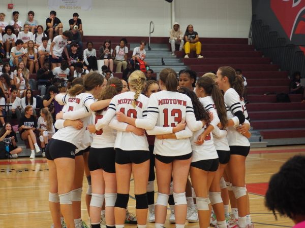 The varisty volleyball team huddles up before their opening match of the season against North Atlanta on Aug. 10th. The Knights won in straight sets 3-0.
