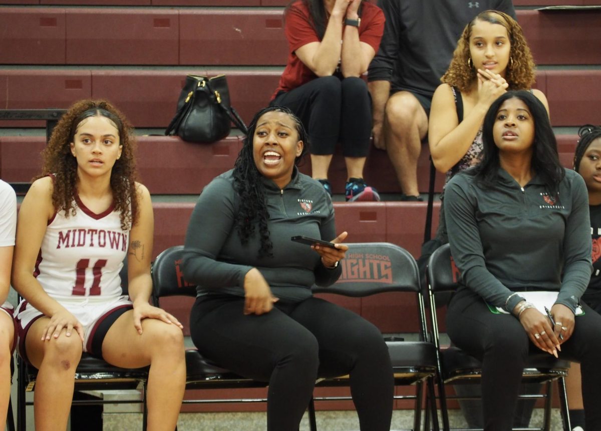 Assistant coach Khaalidah Miller (left) with assistant coach ONeisha Smith (right) instructing from the sidelines during varsity girls basketballs season opener against Mt. Paran. The Knights suffered a tough loss, ending 43-65.
