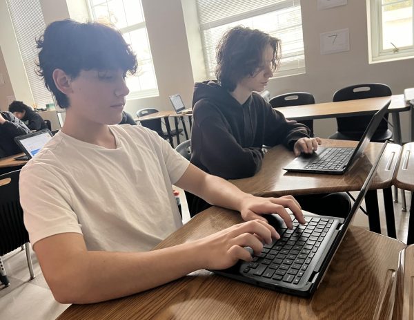 Sophomores Shiloh Majidi (left) and Drake Dominey (right) work on classwork from Big Ideas Learning curricular resources in their geometry class.