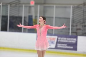 Nationally recognized junior Leia Beinenson poses on ice during a skating competition. 