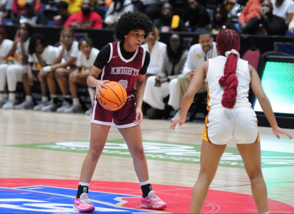 Sophomore Devin Bockman dribbles the ball up the court in the state championship game against Maynard-Jackson High School on March 7. The Knights finished runner-up in the state after losing 58-44. Bockman had a game-high 23 points.