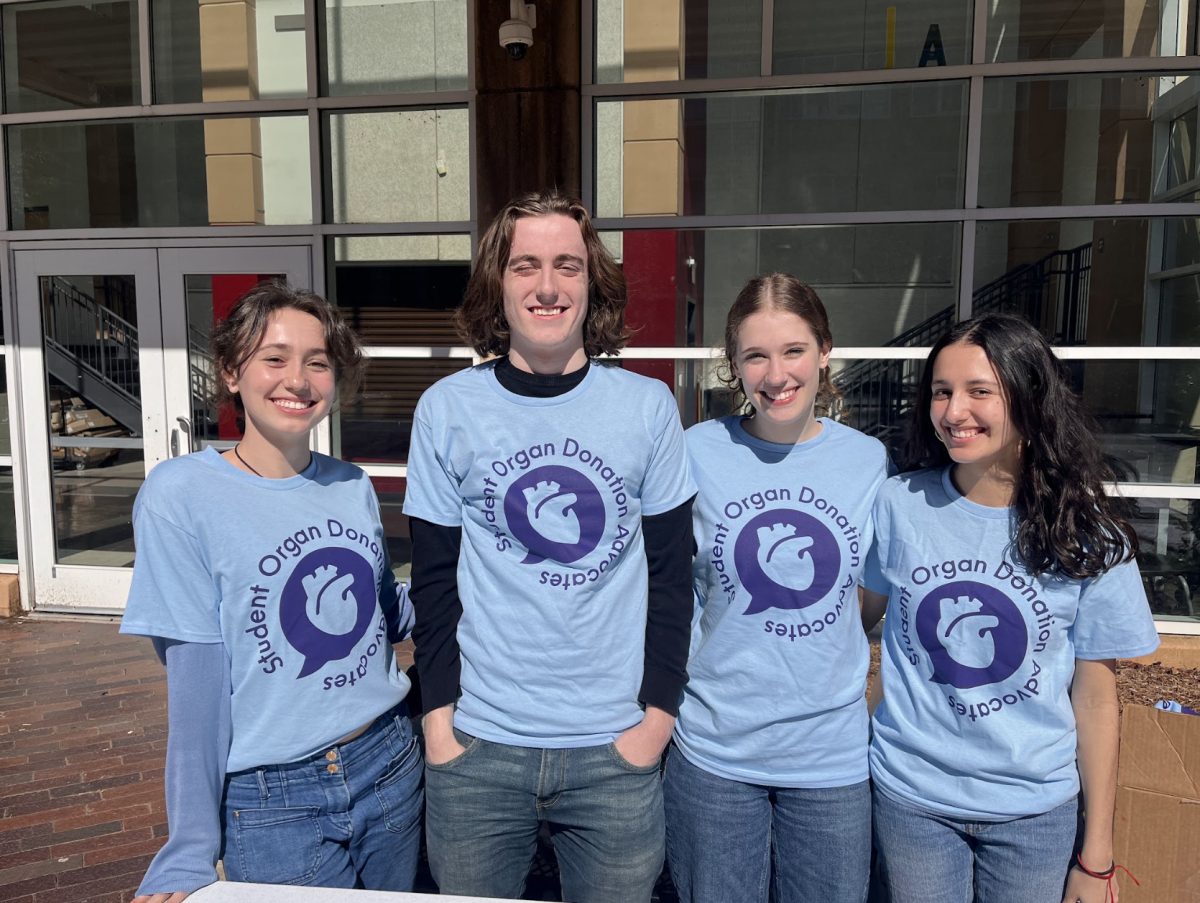 Sierra Pape (left), James Howard, Meredith Bell, and Lucia Olivera (right) work a table for SODA club in the courtyard during lunch on Valentines Day to help register more organ donors on National Organ Donor Day. 