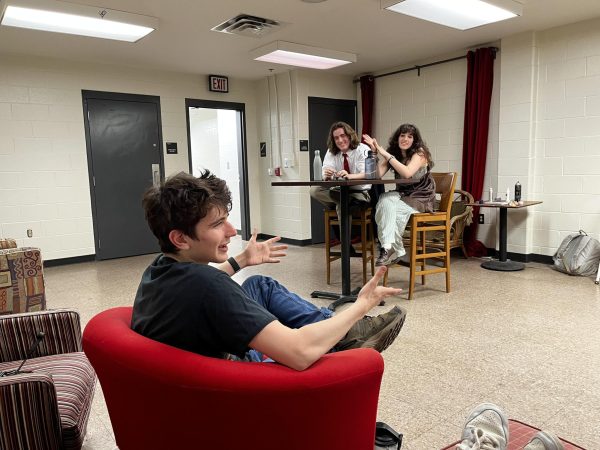 Junior Leo Rose watches the first off-script run of his self-written one-act, The Blue Bar, in which junior James Howard and sophomore Mira Silverman play characters discussing a mysterious past.