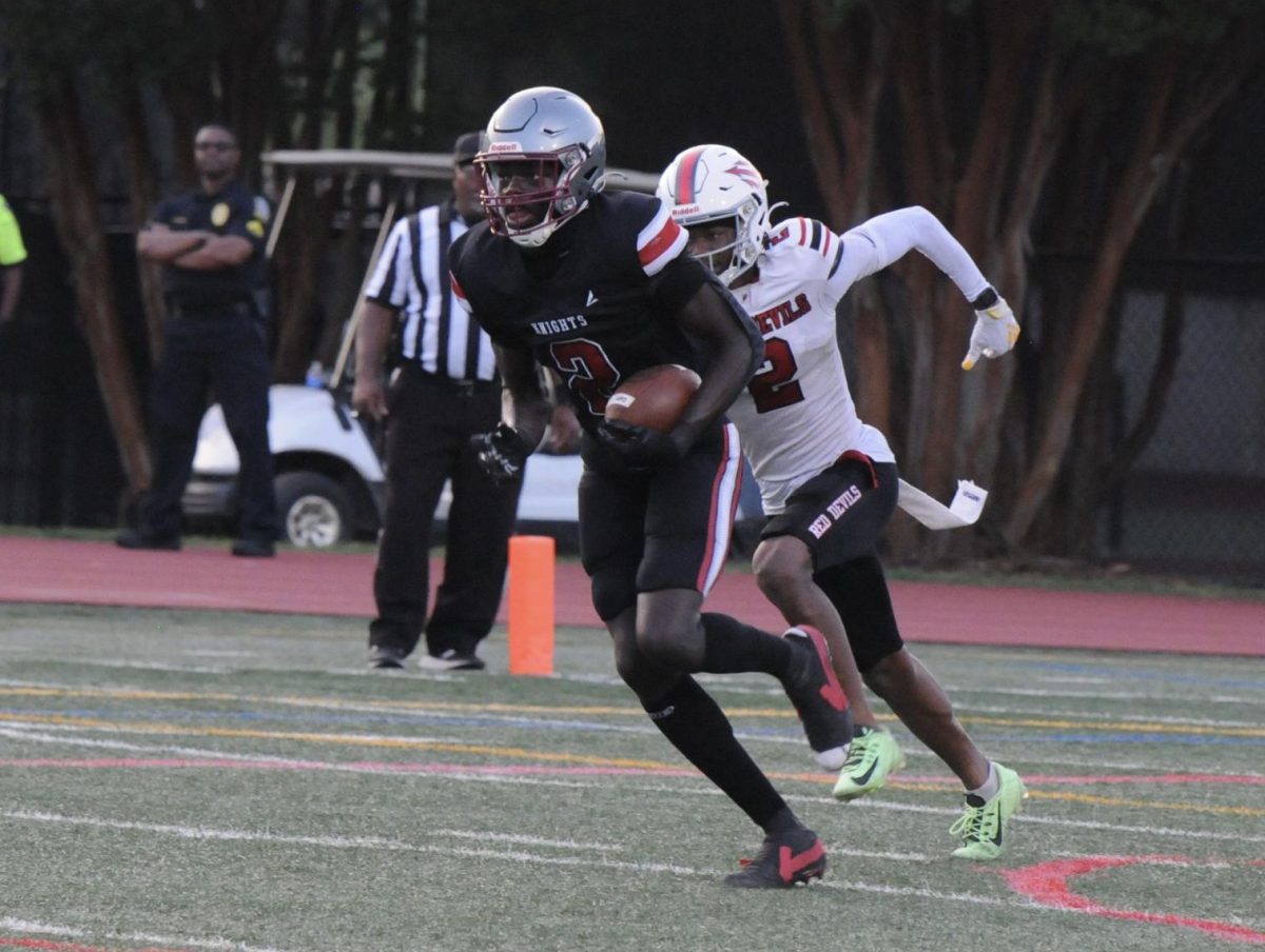 Junior Kentrell White runs back an interception for a touchdown in the Knights' home opener against Druid Hills on August 22. The Knights won 26-14 and White scored two touchdowns in the Knights' first win of the season.