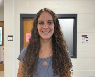 Tegan Derro smiles outside the media center after school