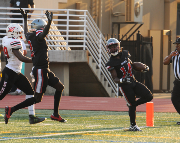 Junior running back Cam Austin scores a touchdown for the Knights in the first quarter of their game against Druid Hills on Aug. 22.  Knights athletics will compete in classification 4A. 