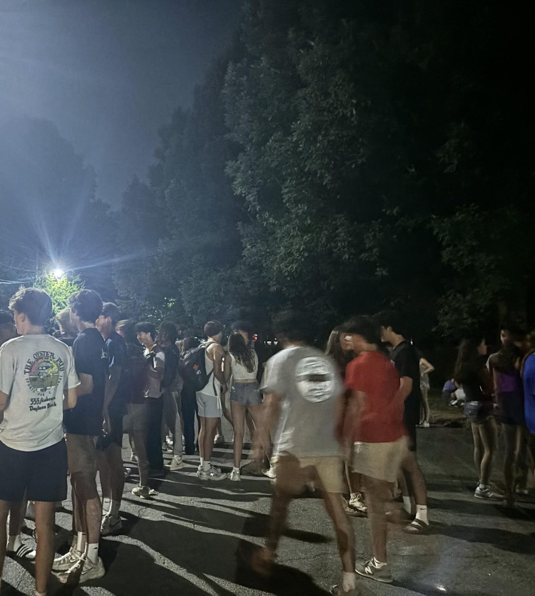 Students gather in Candler Park parking lot. Due to high volume and recent events, some community members are raising safety concerns. 