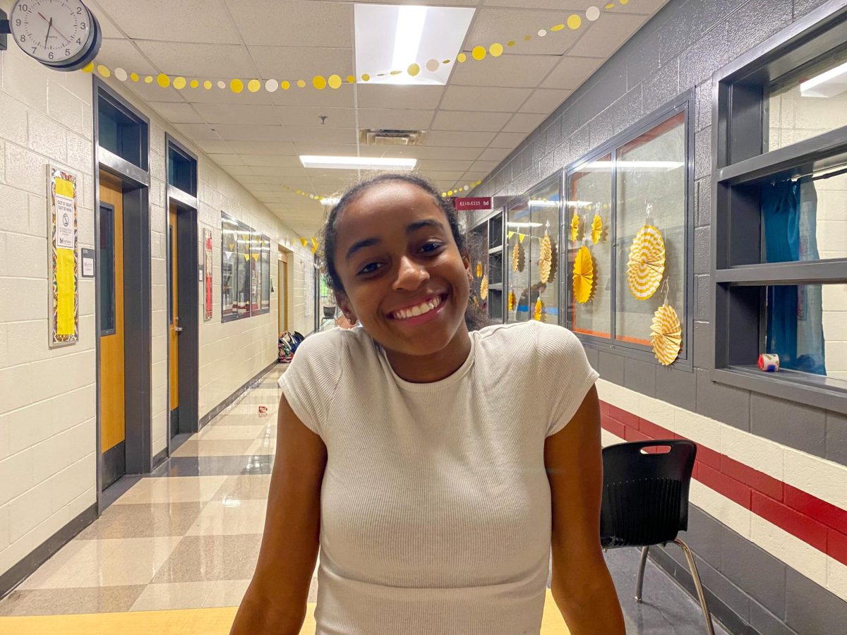 Freshman Cali Smith helps to decorate her class hallway on e200 for homecoming spirit week.