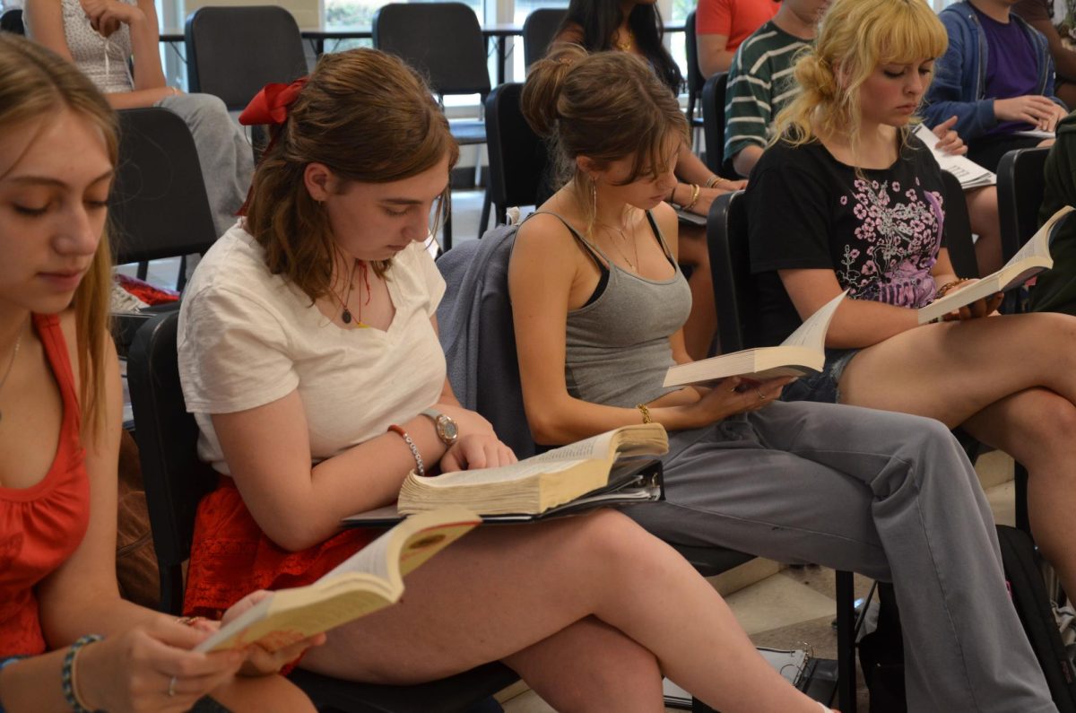 Seniors Lannea Kimmons, Sari D'agastino, Livia Bolster and Emmie Snead read books during class, encouraged by the restriction on phones to pursue other interests in their free time.