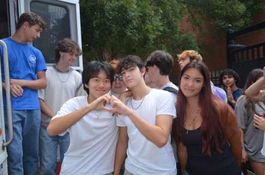 Juniors Minwoo Kang (left), Adam Carr (middle) and Sloane Crisler (right) participate in the Midtown Votes sponsored 'Voter Bus'. At the bus, students register to vote and learn about the voting process by filling out mock ballots.