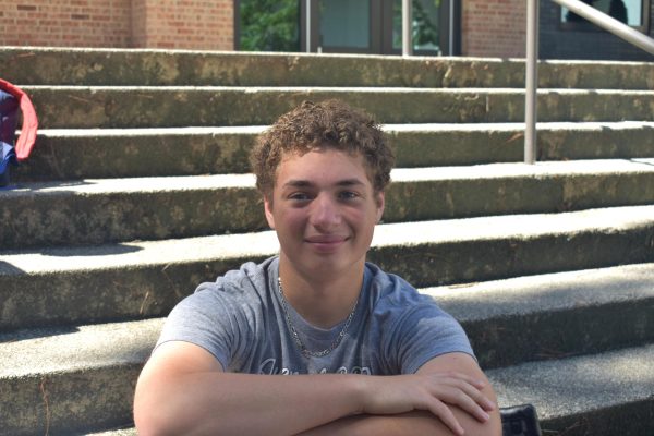 Junior Rajewski enjoys eating his lunch on the steps with his friends