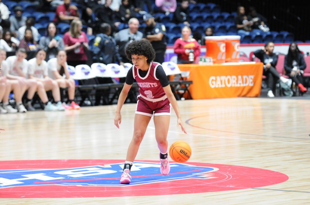 Junior point guard Devin Bockman brings the ball up the court in the GHSA girls basketball State Championship in 2024. 