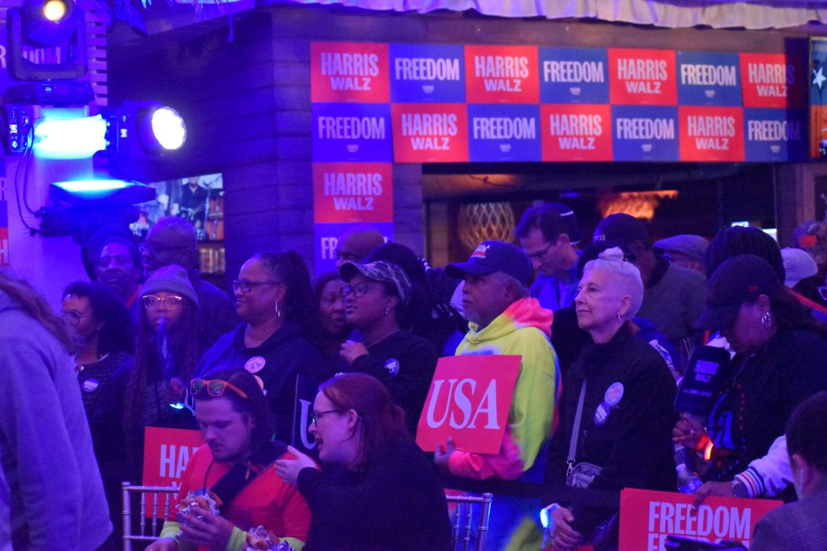 ALL BLUE: The crowd of Harris supporters was cast in blue lights and given signs that said "Harris Walz," "Freedom" and "USA."