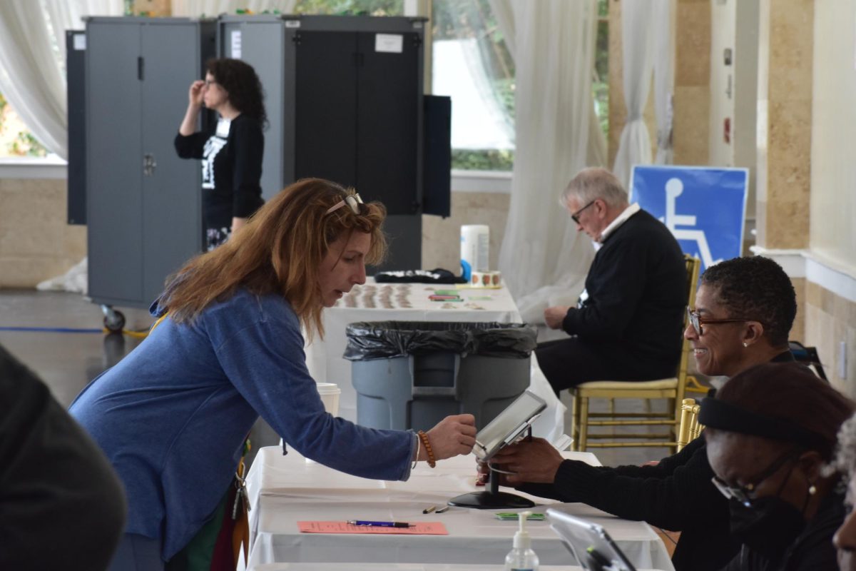 CASTING BALLOTS: At Park Tavern, a steady stream of voters came in and out throughout the day, assisted by poll workers and managers. 