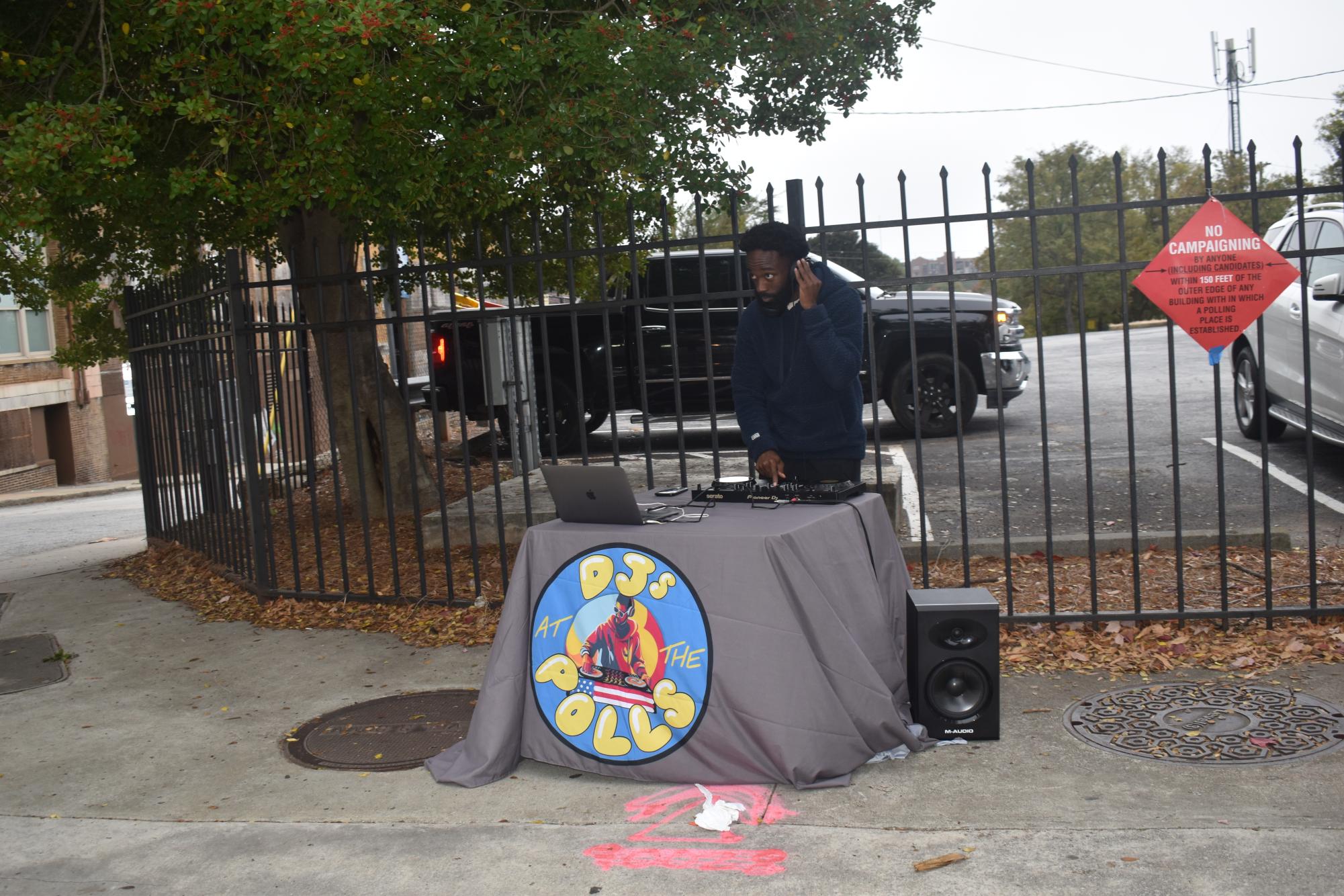 SPREADING THE WORD: DJ Julius Bryant was on the sidewalk outside the voting location he was stationed at. From this location, he was able to communicate with community people and lead them to the polling location nearby.