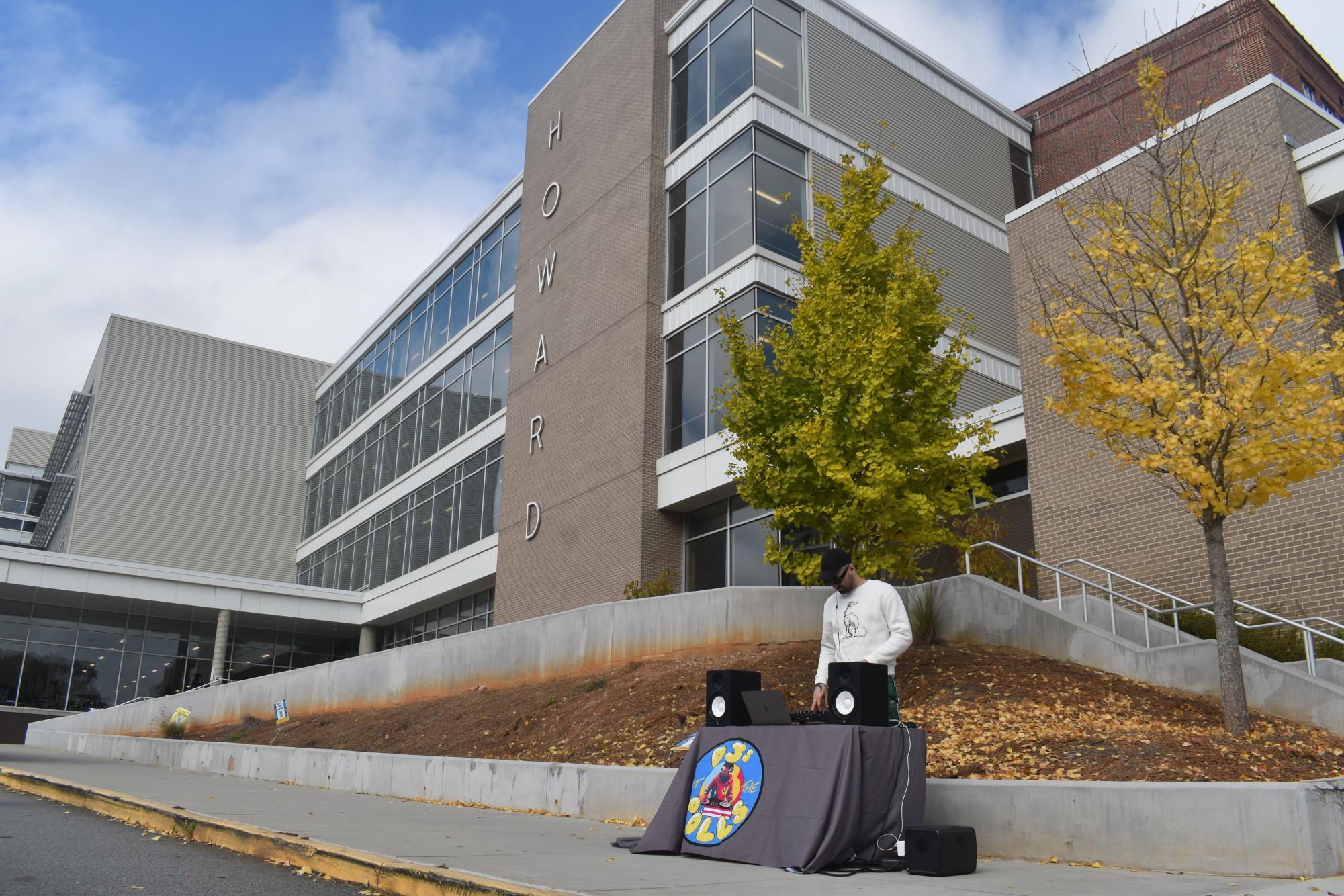 HOWARD VOTES: DJ Wolfsta set up a table outside Howard Middle School. Wolfsta hopes the DJs At the Polls initiative will increase young voter turnout.