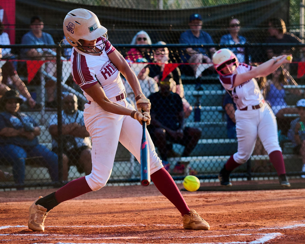 Senior Chloe Peyton swings at a pitch on the Knights' senior night against Pace on Oct. 7. The Knights lost 15-3. Peyton finished the year with a 1.324 slugging percentage which placed her 22nd among all players nationwide in slugging.