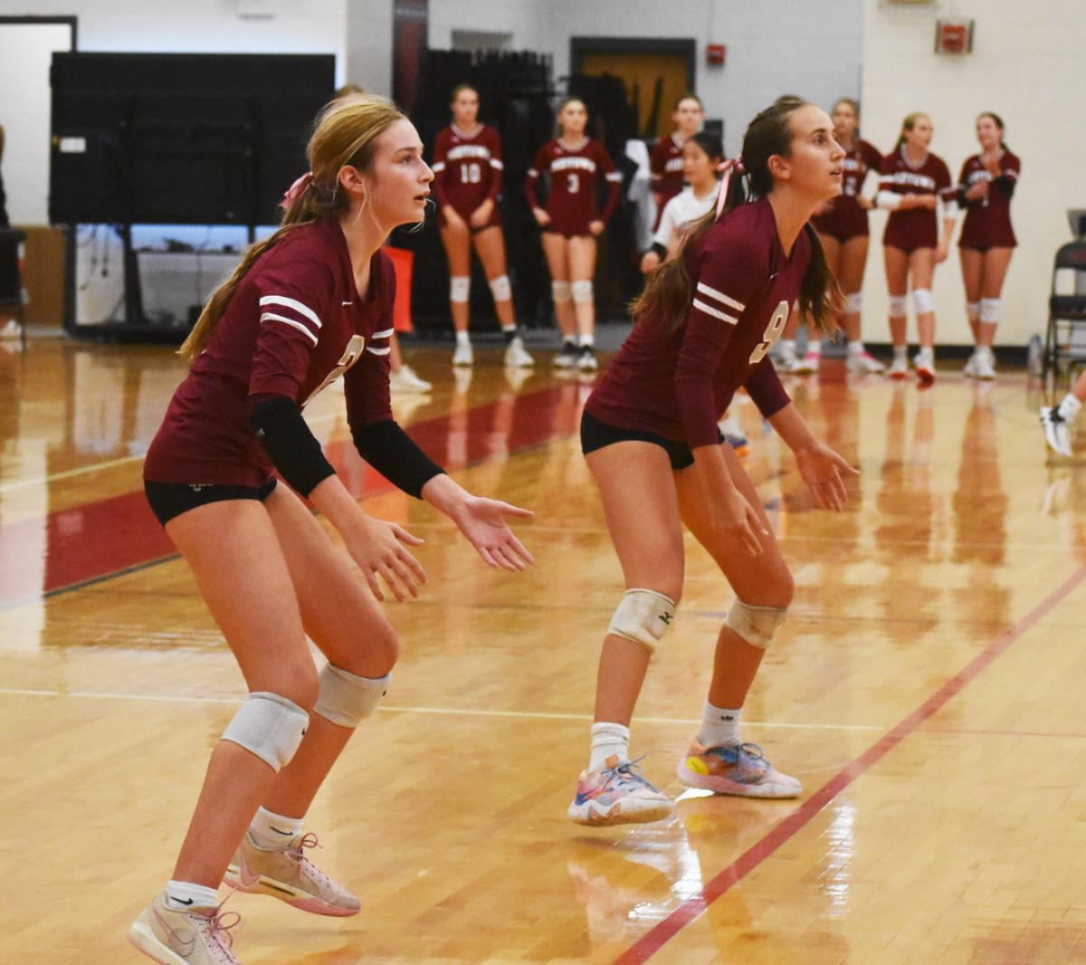 Sophomore Abby Taylor (left) and junior Brennan Fritts (right) prepare to receive the ball against Starr's Mill on Oct 15. The Knights lost the first set, but won the next three, leading to a 3-1 win.