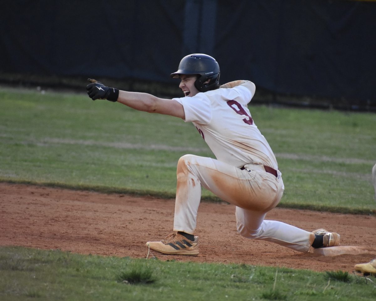 Senior Harrison Briggs celebrates on second base after hitting the go-ahead double in the sixth inning. This put the Knights ahead 5-4 over Jackson which led to their first win over the Jaguars in three years.