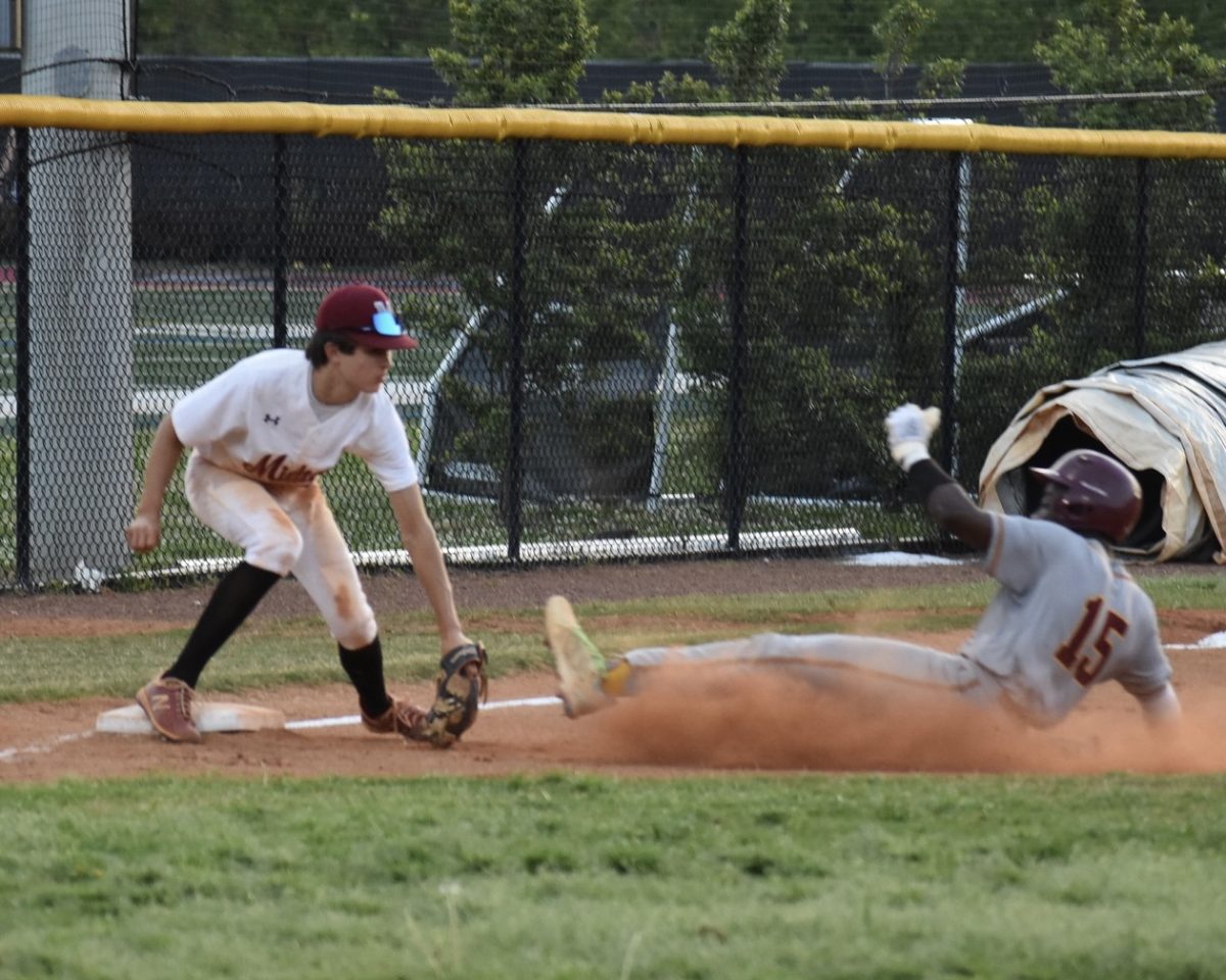 Freshman Patrick Rebillot tags out a runner attempting to steal third base in Midtown's win against Jackson on April 15. Rebillot hit at a .351 batting average this year to lead all underclassmen.