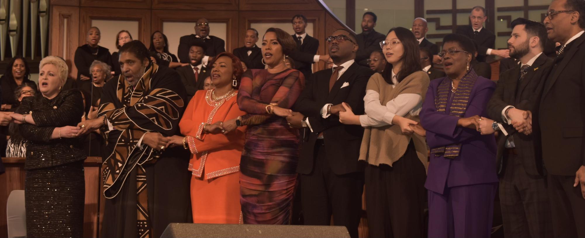 GATHERING TOGETHER: At the end of the service the speakers and congregation joined hands to say a prayer. 