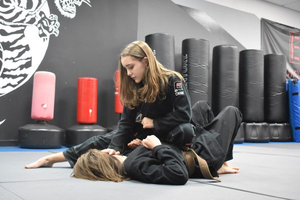 Junior Lizzie Lyman pins down her opponent while grappling. Lyman has been doing martial arts for seven years. 