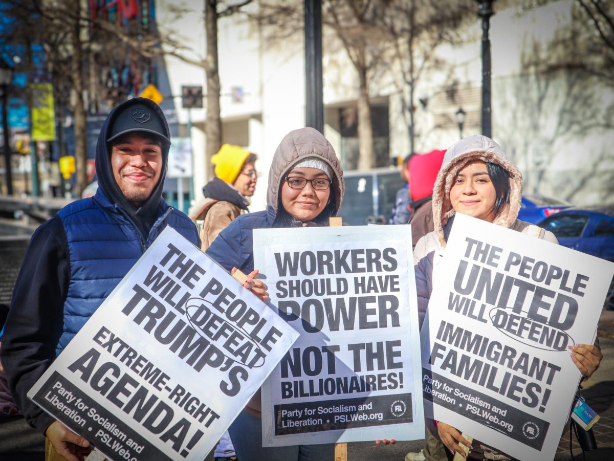 Emory University freshman Landon Diaz and friends protest Trump’s policies on immigration at the We Fight Back rally on Jan. 20.  "If you do your best to just spread a message, people will see that you care, people will see that its important," Diaz said.