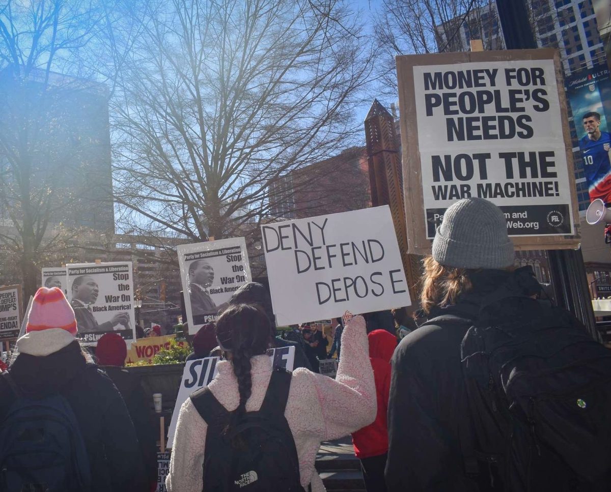 At the We Fight Back rally on Jan. 20, participants hold signs protesting the actions of newly inaugurated President Donald Trump.  Zachary Paz helped organize the event to send the message: "the people will fight back,” Paz said.