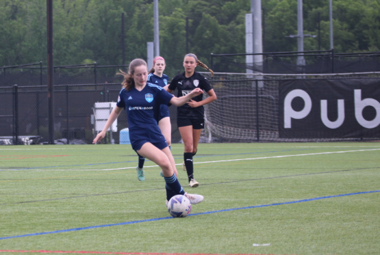 Lark McCormack dribbles in her first soccer game back on May 18 after a year recovery from a torn ACL. Later this game, McCormack retore her ACL, putting her out for another year.