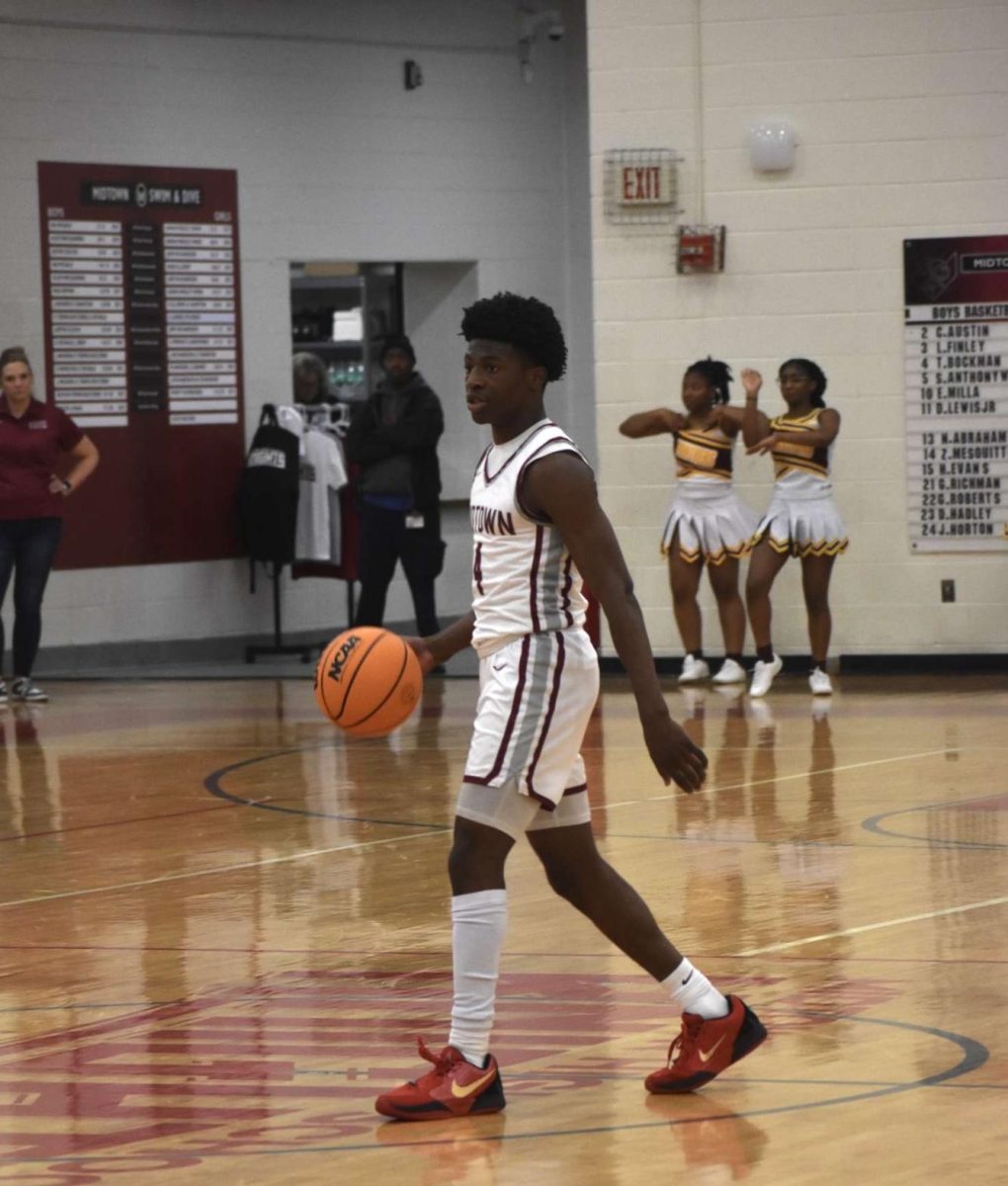 Junior Trent Bockman takes the ball up against Forest Park on Nov. 22. Both Trent and his sister Devin Bockman have played basketball since they were children, and he believes that their dynamic has pushed him to improve as a player.