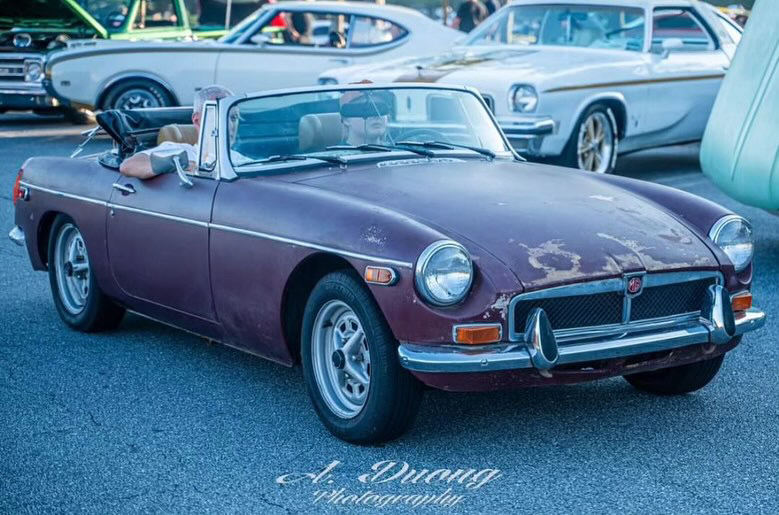 VINTAGE VEHICLE: Nico Brookswolf, alongside his dad Rusty Wolf, displays his MGB car. Brookswolf, who has been interested in cars since he was
six months old, has since repaired multiple parts of the vintage car and continues to hone his skills in vehicle repair by apprenticing at a car shop.