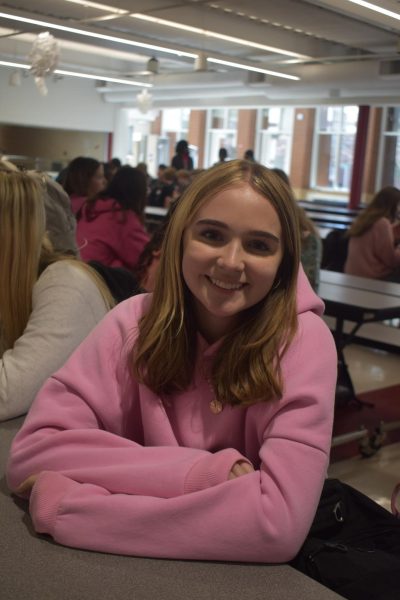 Allen smiles at the lunch table surrounded by her friends.