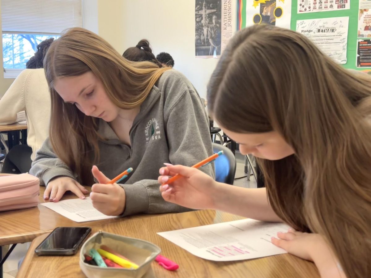 Juniors Charlotte English and Harper Green practice short passage questions at an after-school study session. These sessions provide students with helpful practice and tips for the SAT.