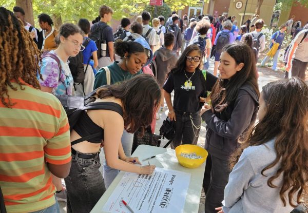 Midtown students sign a safe driving pledge from Impact Teen Drivers in the courtyard.
(Courtesy of Mary Van Atta)