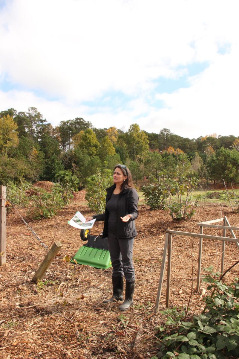 KSU geography professor Dr. Vanessa Slinger-Friedman, who runs the food forest, educates a group of Midtown photography students on the benefits of a food forest. (Courtesy of Arden Henley)