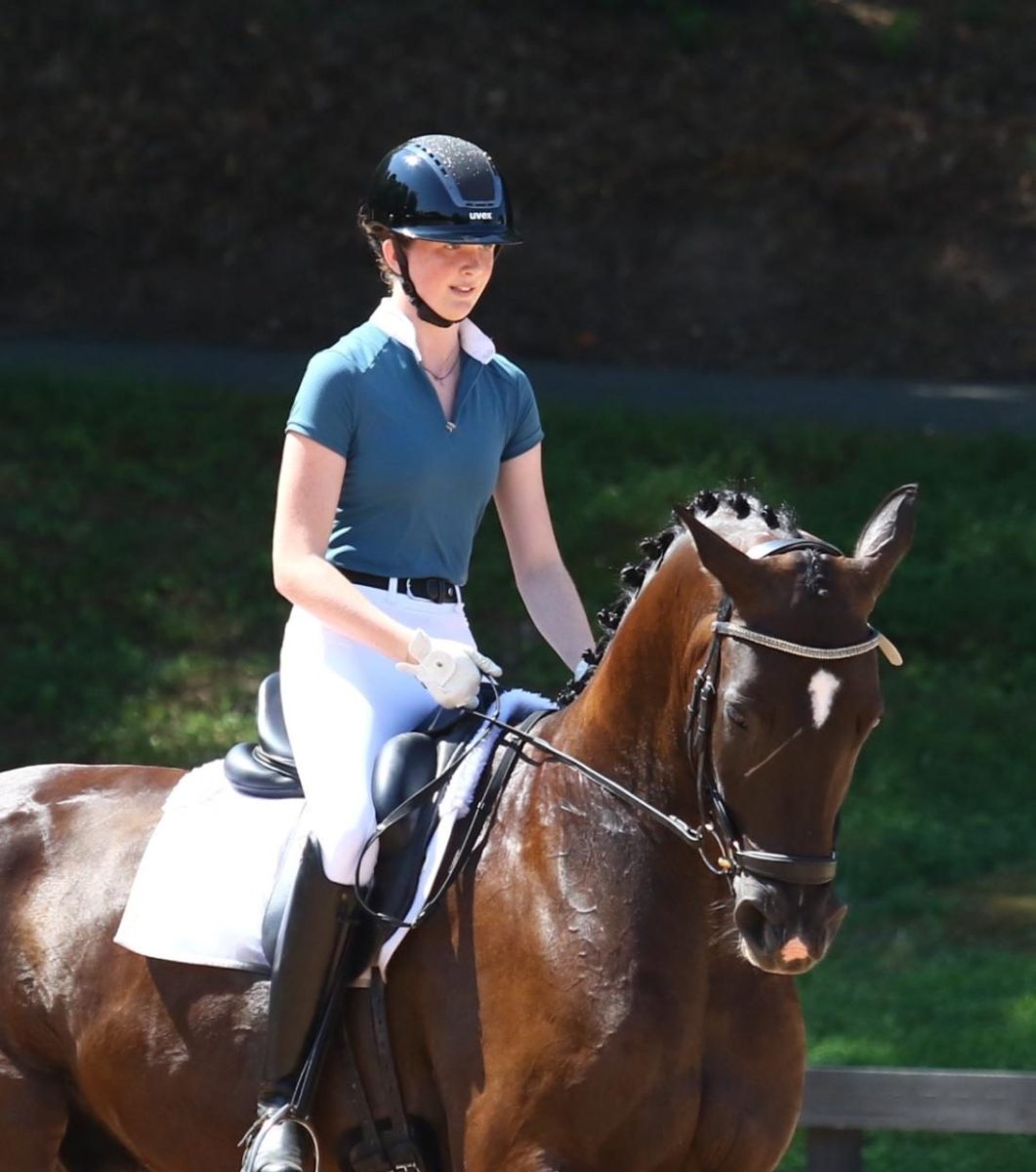 Sophomore Lauren Polk spends most of her free time in the barn, training and taking care of her horse. As she progresses, Polk hopes to train others and compete at the Olympics. (Courtesy of Lauren Polk)