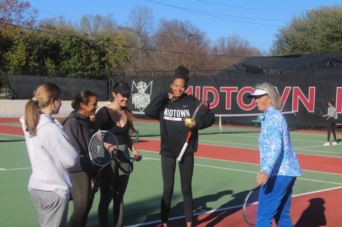 Coach Sandi Stein coaches players Katharine Cardwell, Sienna Burton, Sloane Crisler and Devon Dubose during tennis practice. After her retirement, Stein will focus her time on her pickleball career.