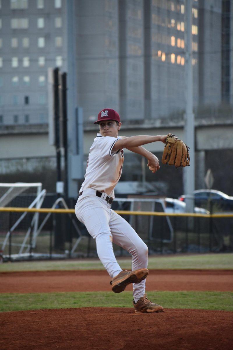 Sophomore Charles Frederick pitches at the March 21st game against Maynard Jackson High School.