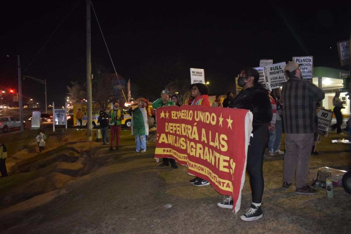 HIGHWAY PROTEST: Near an entrance to Plaza Fiesta, protesters lined the highway, screaming chants and holding signs for passing cars to see. 