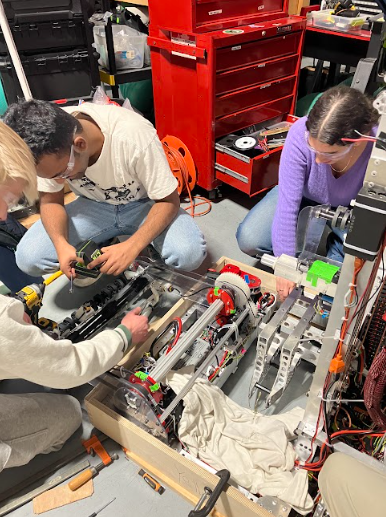 Robotics team members construct their robot for this years competition, ReefScape.