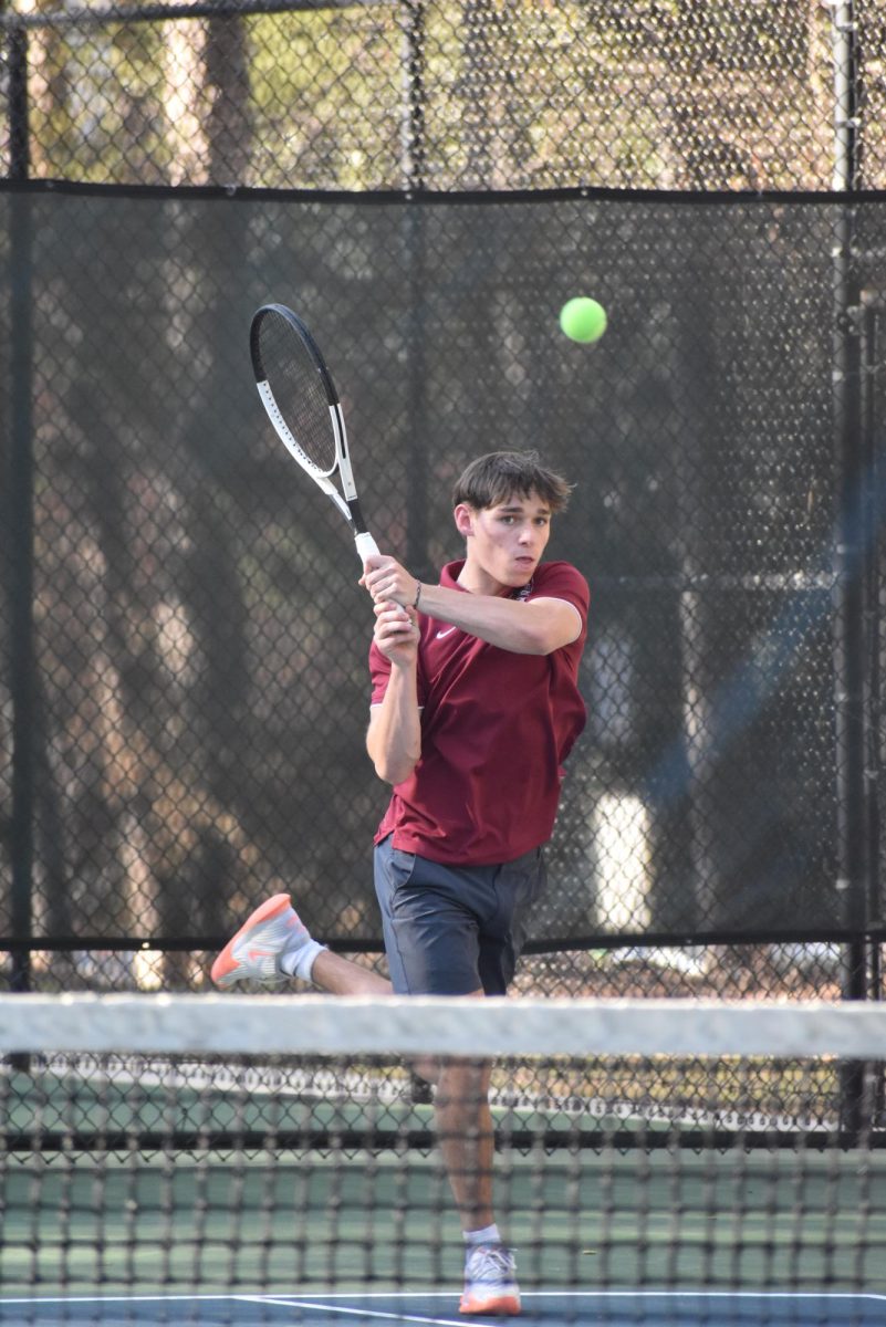 Senior Luca Geissler-Norseng hits a backhand shot against the Westminster
Wildcats on March 25. The boys tennis team lost the match 5-0. The Knights also fell to Westminster during the semifinals of the 4A state playoffs.
