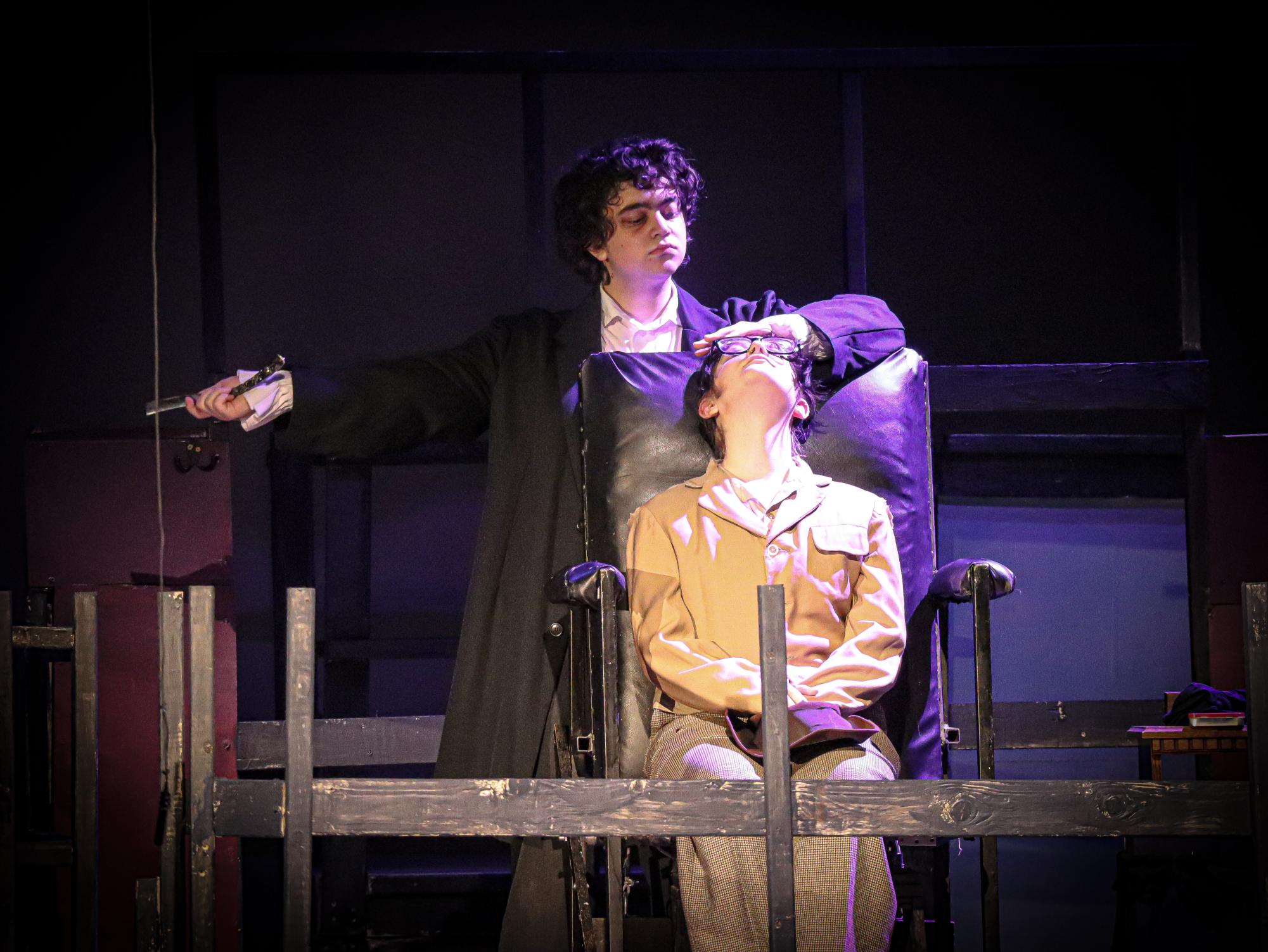 Drawing back his knife, junior Jack Morris, playing Sweeney Todd, prepares to take the life of his victim who came in for an innocent trim. Afterwards, man with cap, played by senior Larai Taro, would be dropped from the barber chair to underneath the platform, a system carefully designed by the set constructors of "Sweeney Todd."