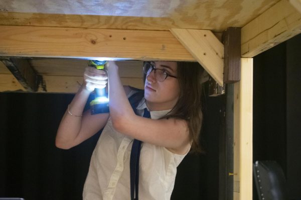 SWEENEY TODD STRIKE: Sophomore Alex Moyer is working in their technical theater class to take apart the set of "Sweeney Todd." Now that the show is over, striking the set will allow the stage to be used for other events and future productions at Midtown.  