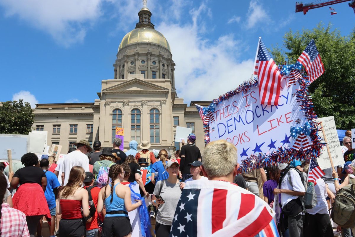 PATRIOTIC PEOPLE: Protester Nick Scheidly came draped in an American flag in an effort to show that the anti-Trump movement is democratic and patriotic.