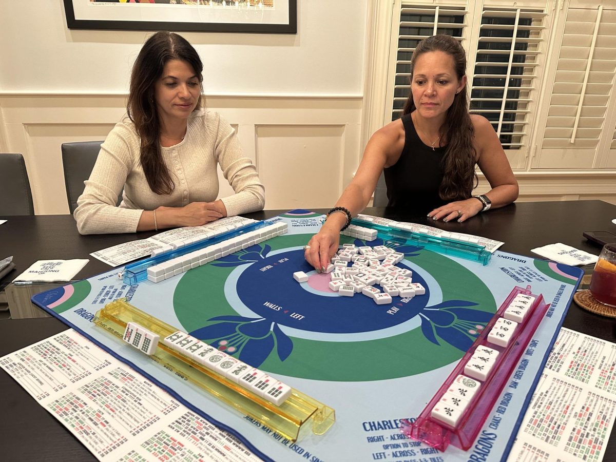 Sarah Agarwal (right) plays the Chinese tile game mahjong with Midtown moms.