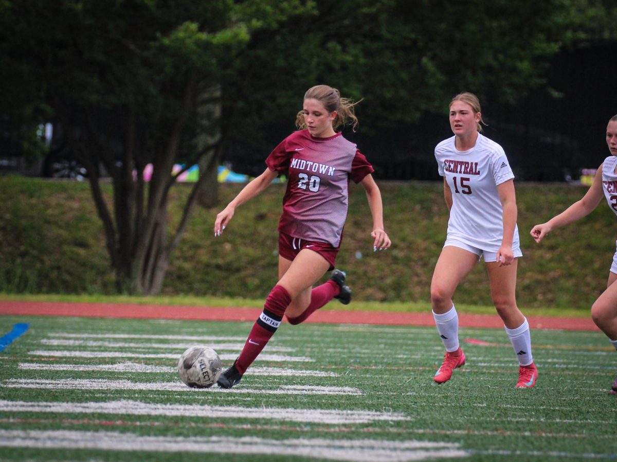 Junior Eve Namias runs down the field with the ball in the Knight's game against Central, where the girls won 10-0.